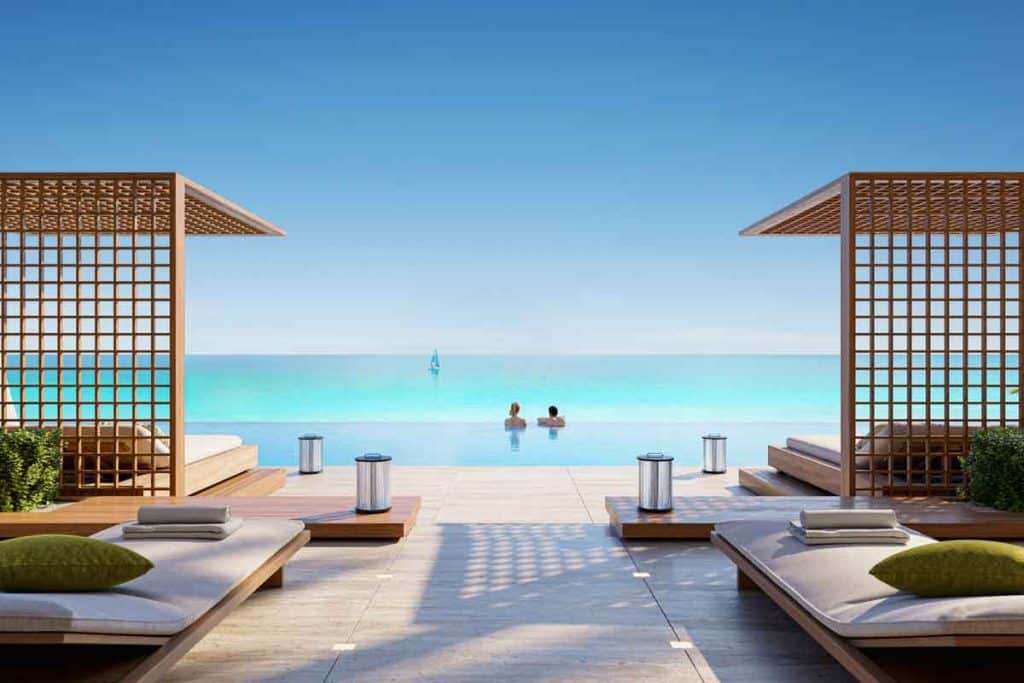 Waterfront exterior facade of Nobu Residences by Aldar Properties in Abu Dhabi, highlighting sleek modern architecture and oceanfront terraces.